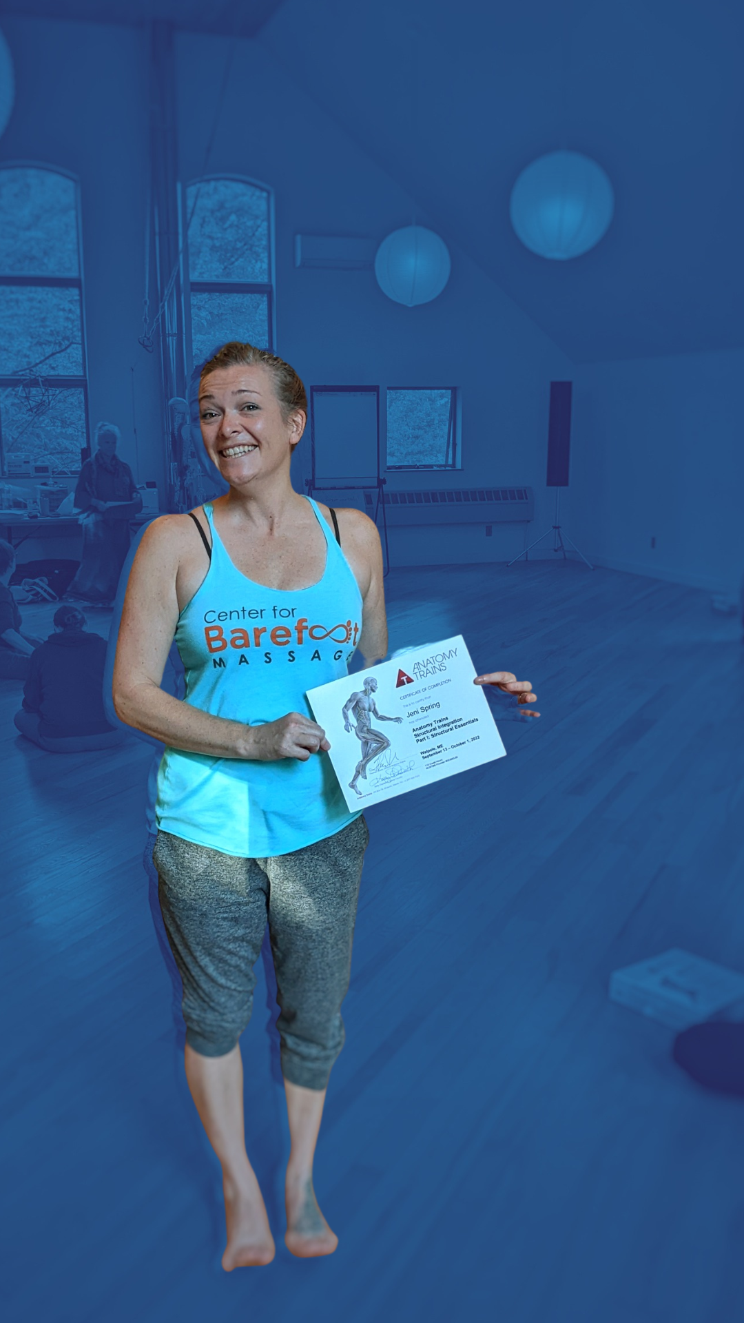Jeni Spring holding her Anatomy Trains Structural Integration certificate 